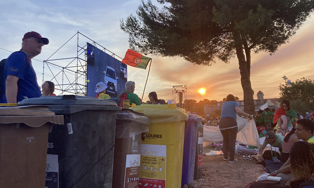 The sisters' view of the screen at the vigil, through the trashcans, watching Pope Francis' arrival (Courtesy of Libby Osgood)