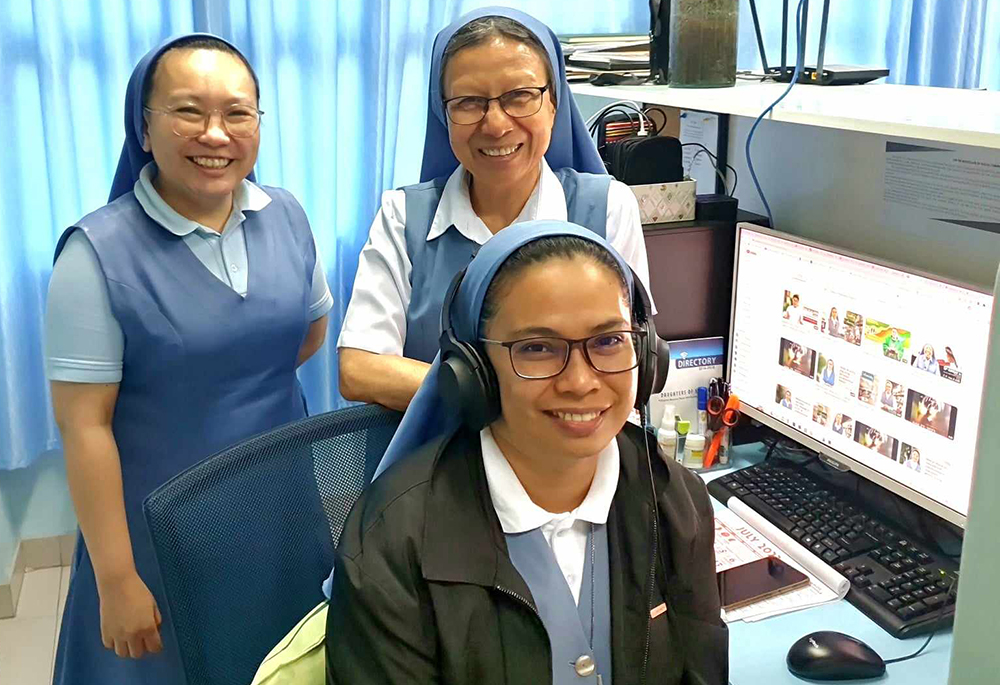 Pauline Sr. Pinky B. Barrientos (standing on right) with Sr. Parichat Jullamonthon (standing on left) and Sr. Josephine Tablante (seated in front). Jullamonthon and Tablante are in charge of the congregation's media production studio at the provincial house and communication center building. The provincial house and communication center building is located across the street opposite the central house. (GSR photo/Oliver Samson)