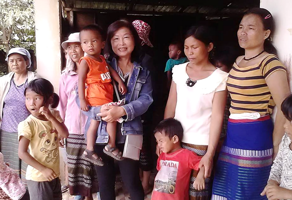 Apostolate Auxiliaries Sr. Agnes Le Thi San (center) visits women who have been given material and spiritual support to avoid abortions in A Luoi District of Thua Thien Hue province, June 10. (GSR photo/Joachim Pham)