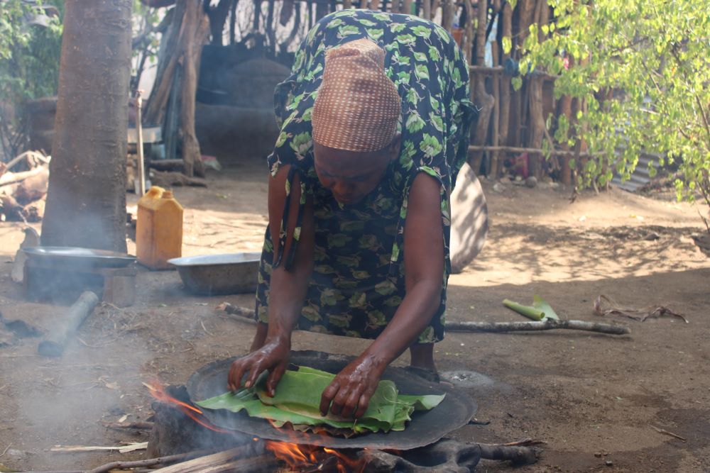 Woman cooking on an open fire