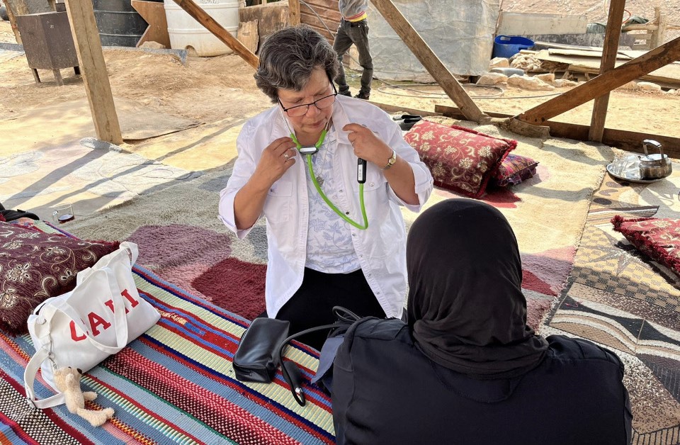 La hermana Julia Hurtado atiende a un beduino anciano en el campamento beduino de El Montar, en el desierto de Judea. Dos veces a la semana, viaja unos 45 minutos en autobús para reunirse con dos hermanas Combonianas, y luego recorren juntas largas distancias por caminos de tierra llenos de baches para llegar a los campamentos del desierto. (Foto: cortesía de Julia Hurtado) 