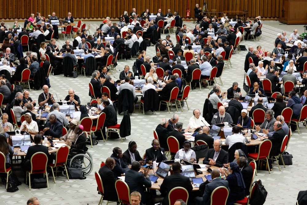 People sit around several round tables