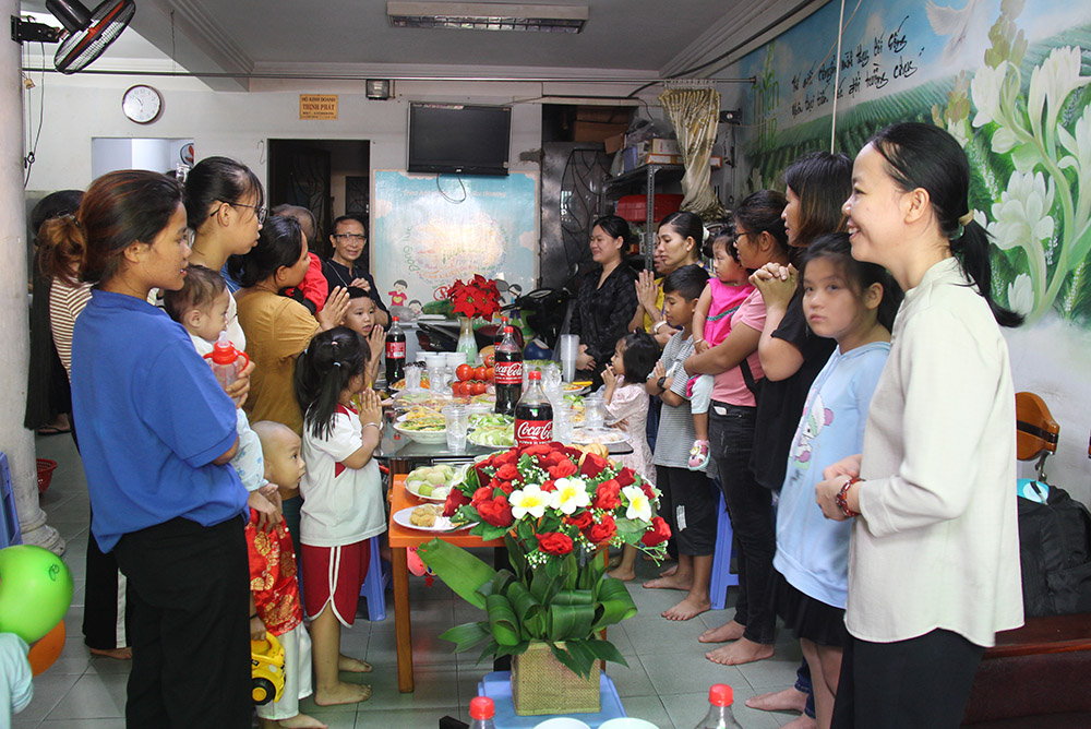 Following the city tour, Dominican Sr. Mary Dinh Thi Thanh Xuan (right) treats children and their relatives to a big party at the home for heart patients on Sept. 30. (GSR photo/Joachim Pham)