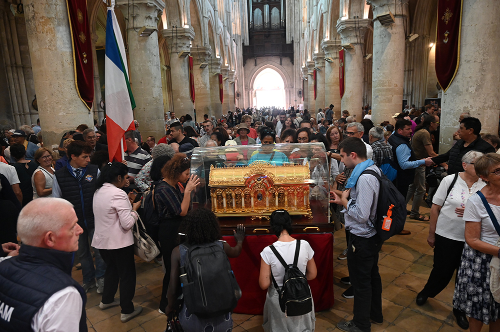 Pilgrims pray over the reliquary of St. Thérèse of Lisieux Oct. 1 in Lisieux, France. Nearly 30,000 pilgrims flocked to Lisieux for the so-called Theresian feasts, celebrated Sept. 30-Oct. 8 in France's northern Normandy region, where the famous French saint, born Jan. 2, 1873, lived and died. (OSV News/Courtesy of Sanctuary of St. Thérèse of Lisieux)