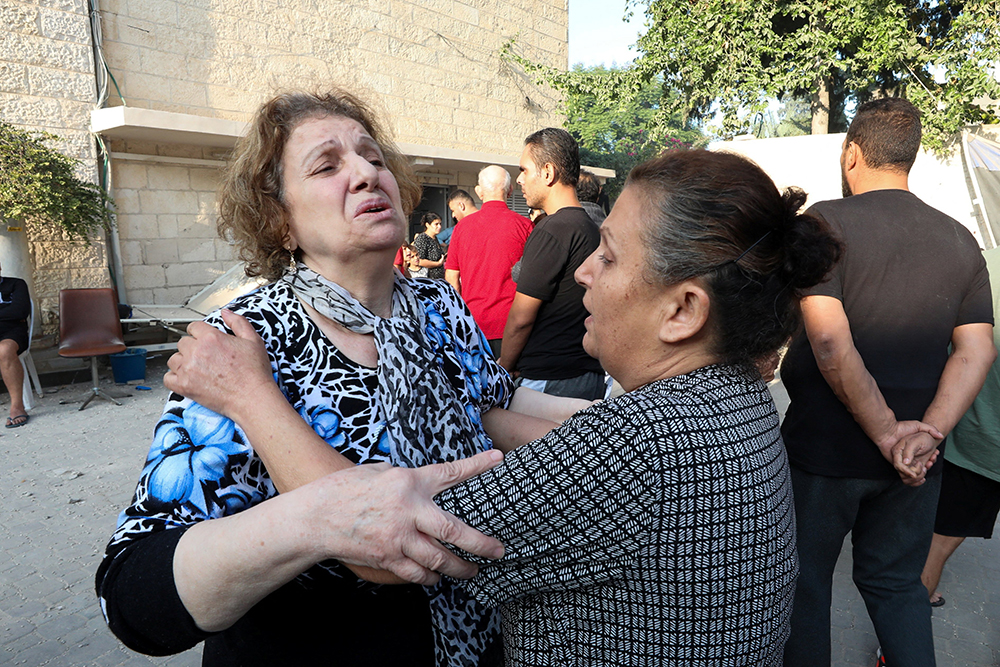 Women react outside St. Porphyrios Greek Orthodox Church in Gaza Oct. 20 after an explosion went off the night before. Several hundred people had been sheltering at the church complex, many of them sleeping, at the time of the explosion. The Hamas Ministry of Interior in Gaza blamed the explosion on an Israeli airstrike but responsibility for it had not yet been independently verified. (OSV News/Reuters/Mohammed Al-Masri)