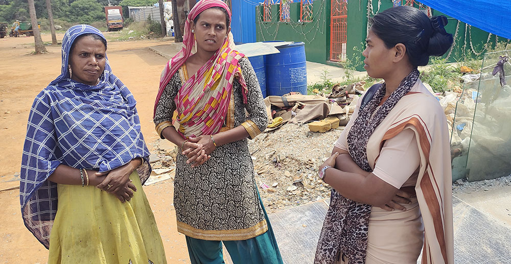 Poor Handmaids of Jesus Christ Sr. Elizabeth Lugan, right, a social worker of the Ashalaya and the hostel warden, interacts with women in Bellahalli garbage segregation unit on the outskirts of Bengaluru in southern India. (GSR photo/Thomas Scaria)