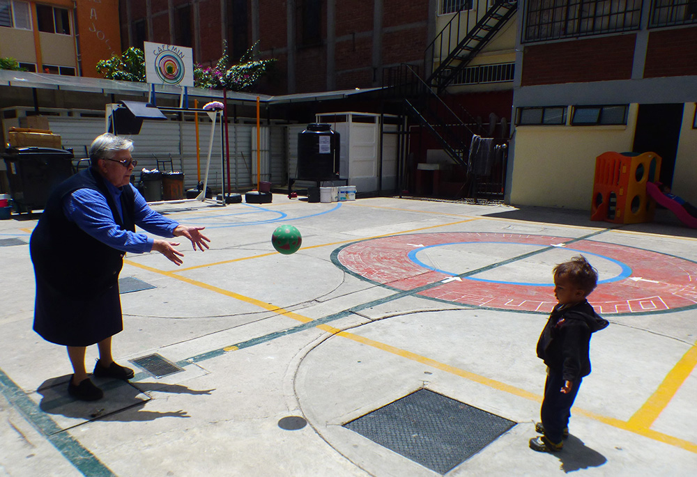Josephine Sr. María Soledad Morales Ríos plays ball with a child Aug. 24, at the CAFEMIN shelter in Mexico City. For the past two years, the shelter her congregation operates, with a capacity to serve 100, has had to make room for up to 800 given the rising numbers of migrants passing through Mexico City. (GSR photo/Rhina Guidos)