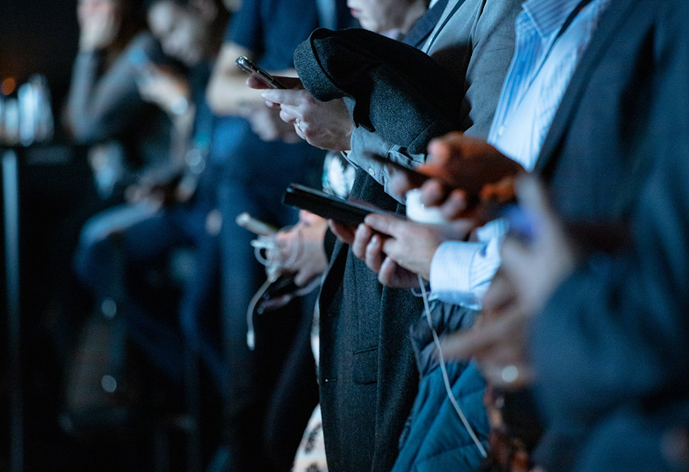 Photo illustration of people using phones (Unsplash/Camilo Jimenez)