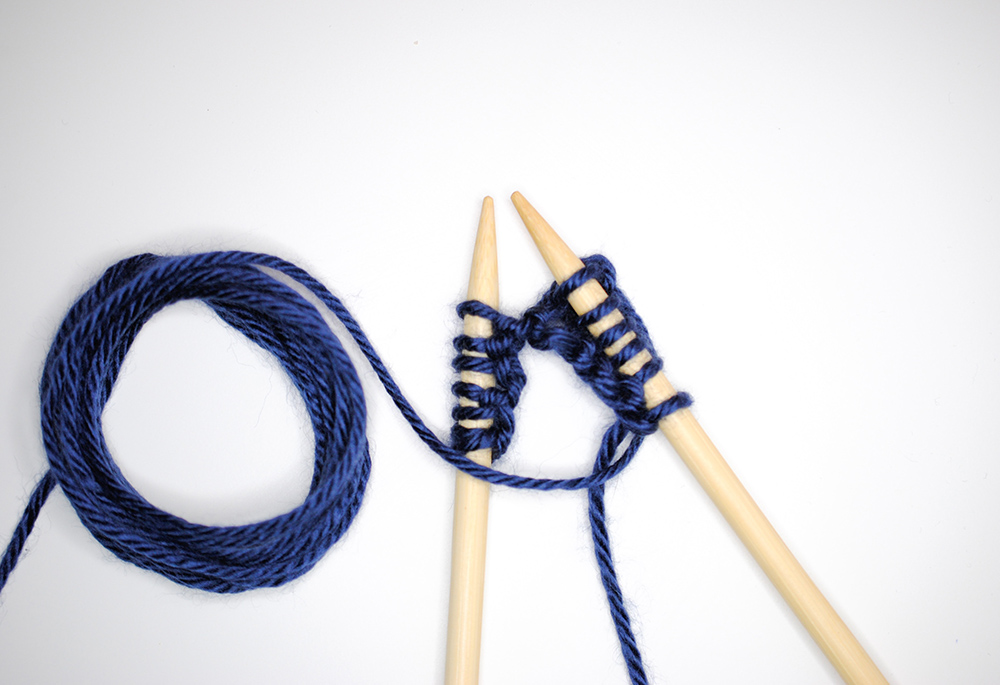 Photo illustration of knitting needles and yarn (Unsplash/Nik)