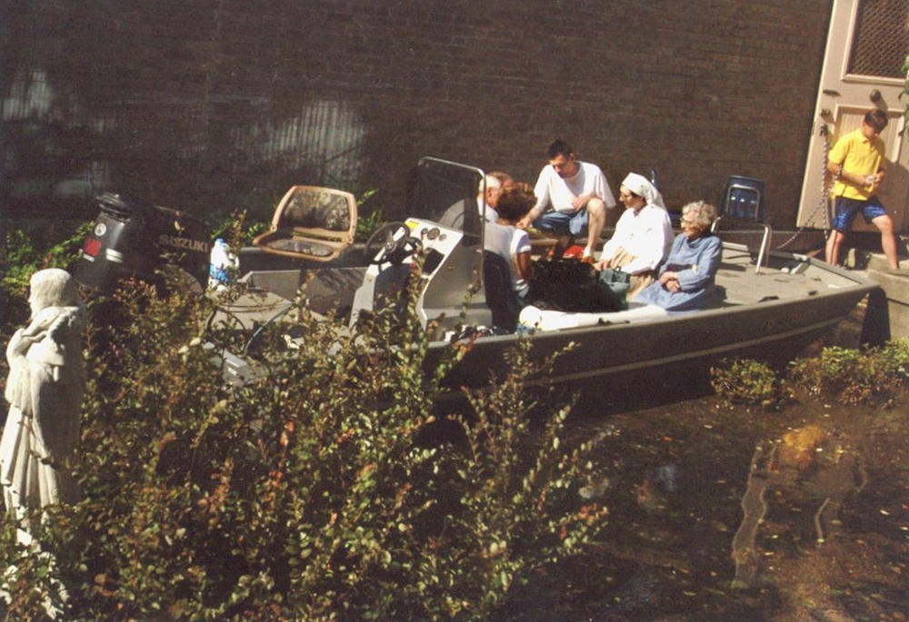 The Ursuline sisters of New Orleans are rescued by boat roughly a week after Hurricane Katrina hit in 2005. Ursuline Sr. Carolyn Brockland said that the sisters insisted the neighbors sheltering with the sisters also be evacuated. The sisters took special care to make sure each boat had both sisters and laypeople so that no one got left behind (including the dogs). (Courtesy of The National Votive Shrine of Our Lady of Prompt Succor)