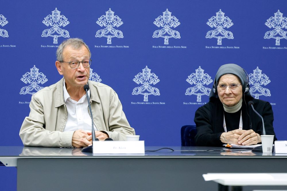 Br. Alois, prior of the ecumenical Taizé Community, speaks during a briefing about the assembly of the Synod of Bishops as Benedictine Mother Maria Ignazia Angelini, a theologian, listens at the Vatican Oct. 27. (CNS/Lola Gomez)