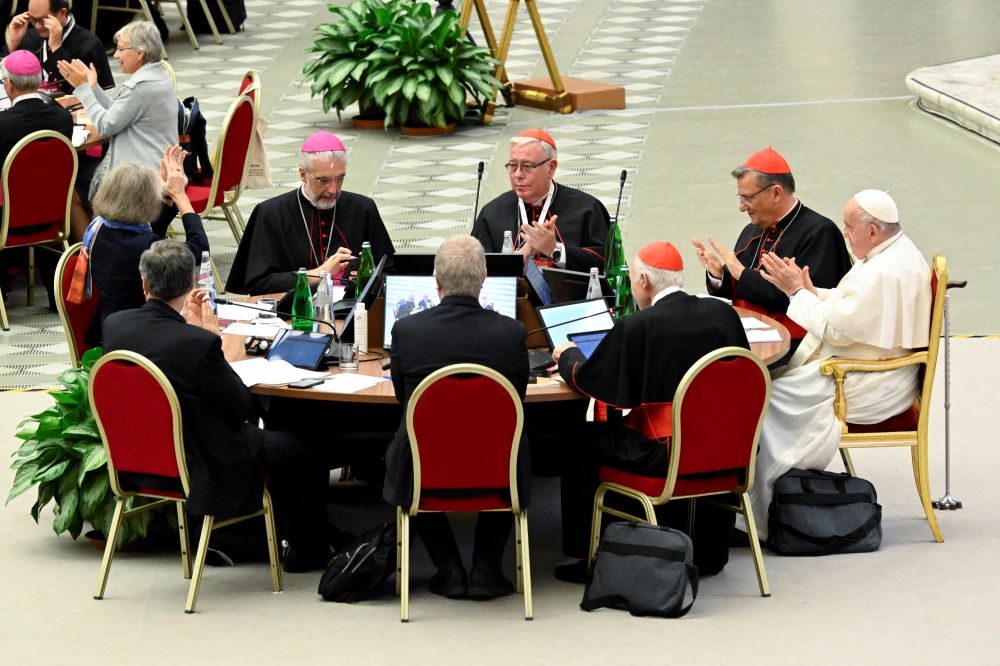 Pope Francis and leaders of the assembly of the Synod of Bishops applaud at the conclusion of the gathering's last working session Oct. 28  in the Paul VI Hall at the Vatican. (CNS/Vatican Media)