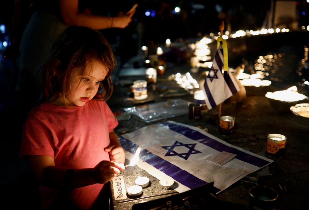 A girl lights a candle