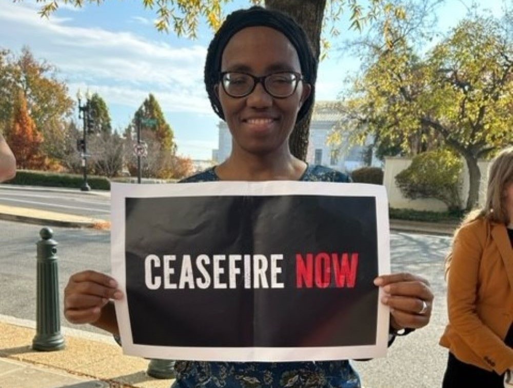 Woman holds sign: "Ceasefire Now"