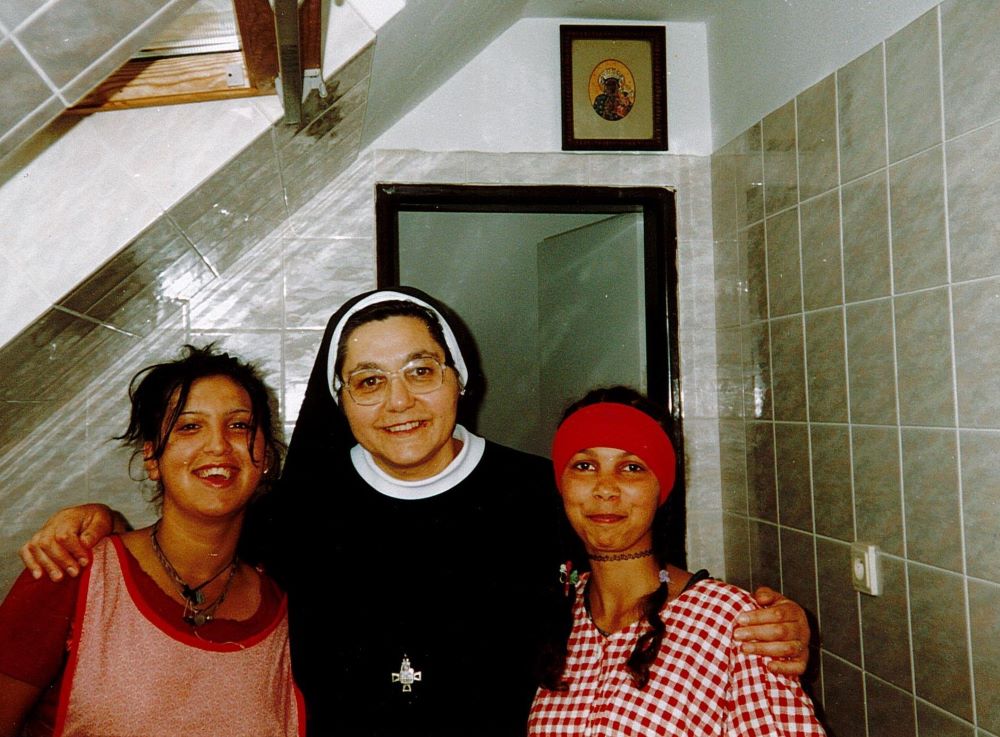 Sr. Atanazia Holubova poses with Romani teenage girls while baking cookies in the Pastoral Center for Romani in Poštarka, Slovakia. (Courtesy of Emanujila Vishka)