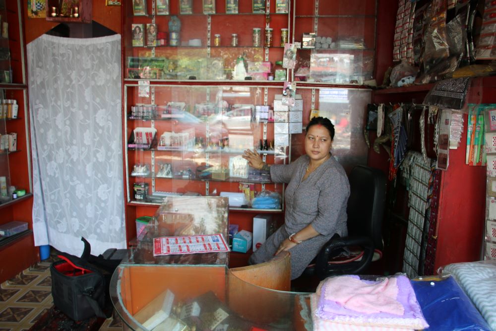 Woman stands in a shop.