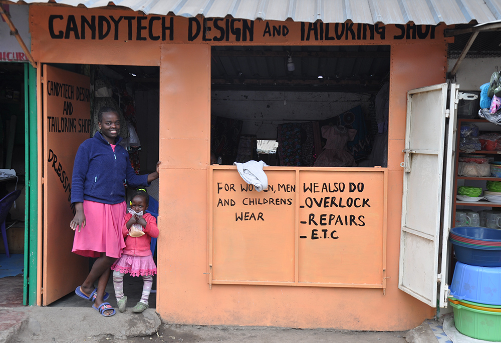 Lynn Chepng'eny and her daughter are pictured at the dressmaking business she and Scovia Nakato started in Kariobangi North in Nairobi. The Association of Sisterhoods of Kenya sponsored the tailoring business by providing machines and assorted materials and paid rent to start them off. (​​Lourine Oluoch)
