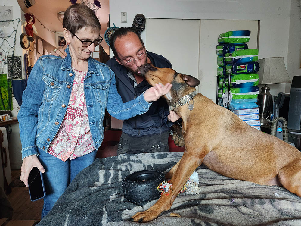 Tommy Dunphy and his beloved dog, Arianna, with friend Sr. Margaret Farrell, left, in Dunphy's small studio apartment (GSR photo/Chris Herlinger)