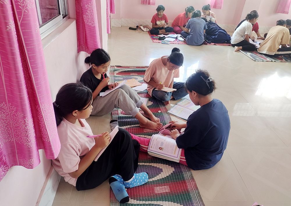 Older girls study with the younger ones at Snehabhavan ("Home of Love"), a girl's orphanage managed by Salesian nuns in Imphal, capital of the troubled Manipur state in northeastern India, after ethnic violence led to the closure of their school. (Thomas Scaria)