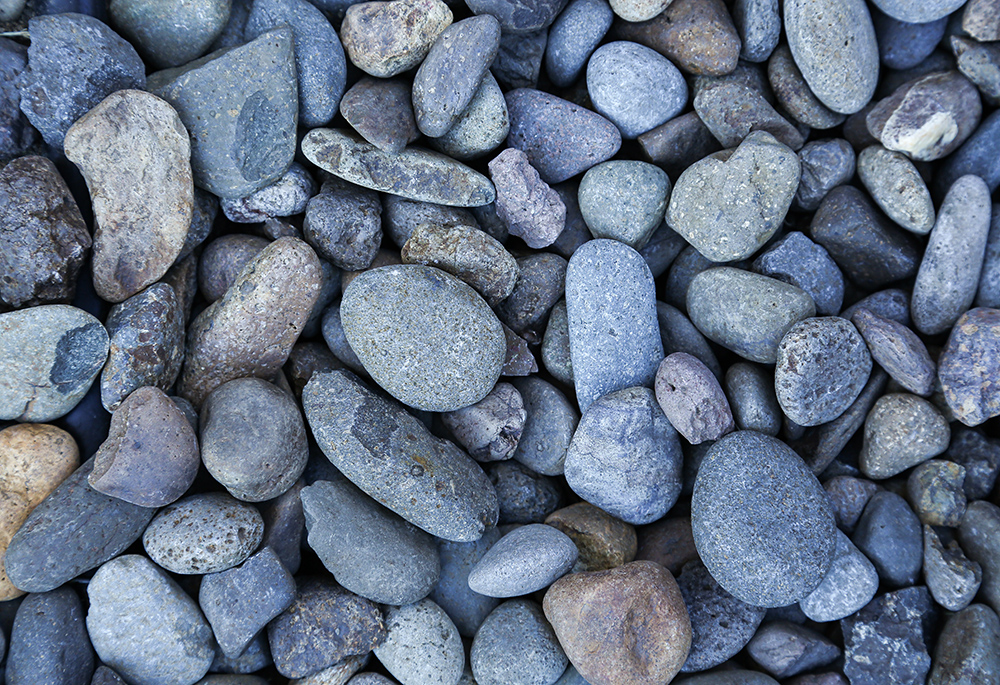 Photo illustration of various rocks with smooth surfaces (Unsplash/Kamal Preet Kaur)