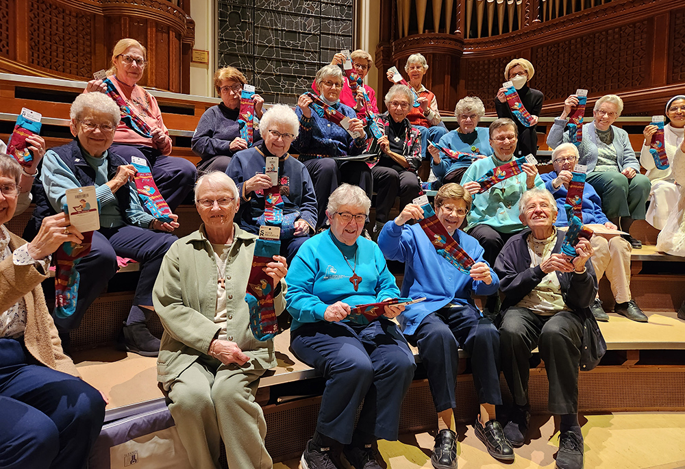 School Sisters of St. Francis singers receive St. Cecilia socks at their final rehearsal before their "Gathering on Holy Ground" concert in November 2022 to celebrate the reopening of St. Joseph Chapel in Milwaukee. (Courtesy of Jane Marie Bradish)