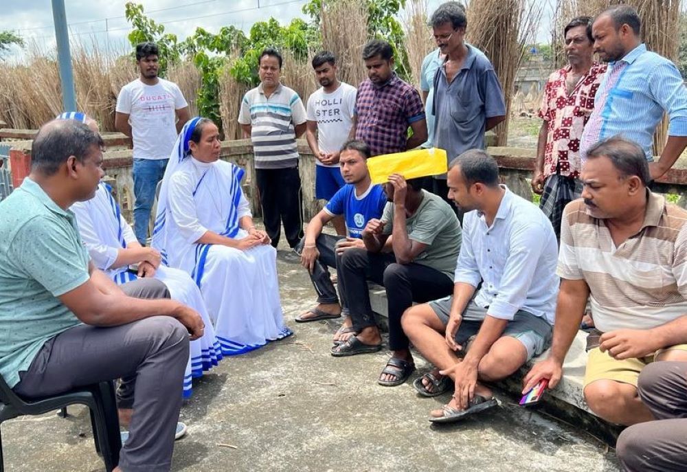 A nun talks to a group of men. 