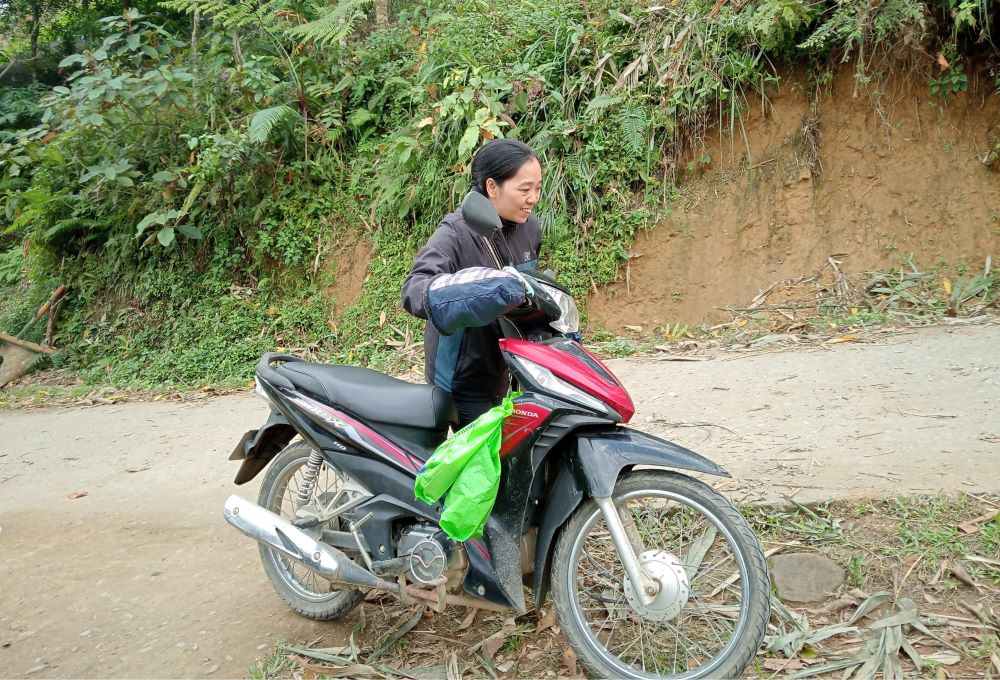 Lovers of the Holy Cross of Hung Hoa Sr. Mary Hoang Thi Phuong rides a scooter on narrow, windy and rough paths to offer pastoral care to Hmong villagers at subparishes in Lao Cai province. (Joachim Pham)