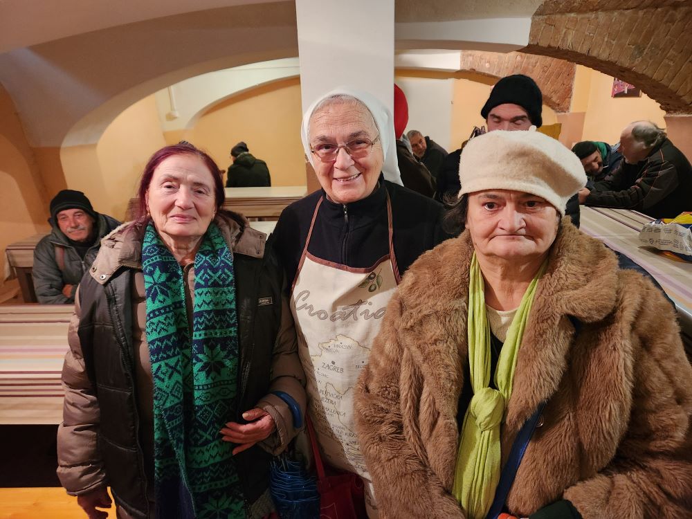 Sr. Tihomira Parlaj, a member of the Sisters of Charity of St. Vincent de Paul of Zagreb who helps coordinate a soup kitchen in the Croatian capital, is seen here with some of those the kitchen serves. (GSR Photo/Chris Herlinger)