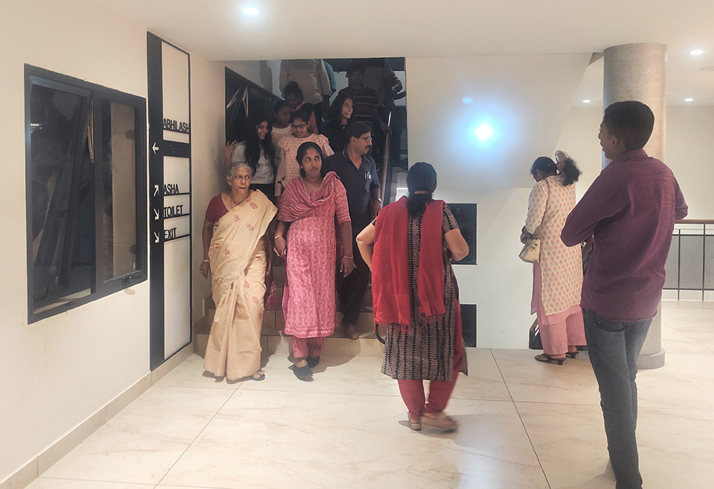 People are pictured coming out of the theater after watching the film "The Face of the Faceless," a biopic on Franciscan Clarist Sr. Rani Maria. (Thomas Scaria)