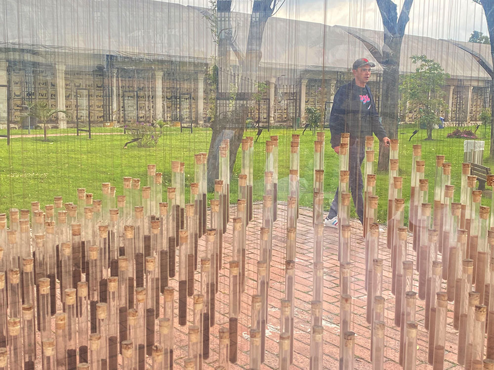A visitor to the Center of Memory, Peace and Reconciliation in Bogotá, Colombia, walks Nov. 22 past an installation of vials filled with soil from the country's towns and cities that suffered violence during the decadeslong conflict between the Revolutionary Armed Forces of Colombia (FARC) and the government. (GSR photo/Rhina Guidos)