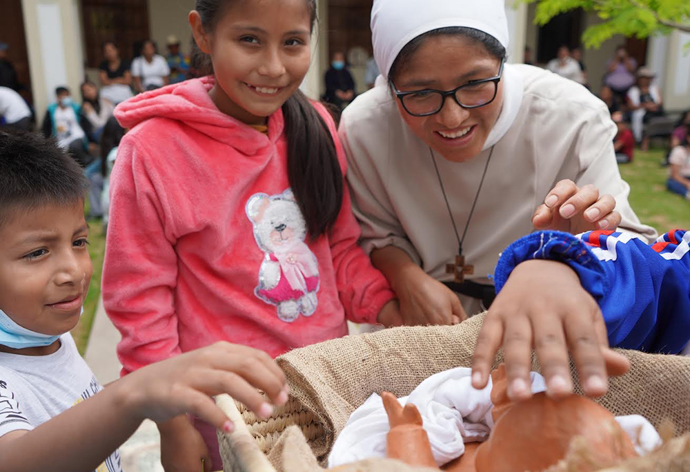 Children come to adore the baby Jesus at the Christmas gathering at the Monastery of the Incarnation in Lima, Peru. (Laura Miyagui)