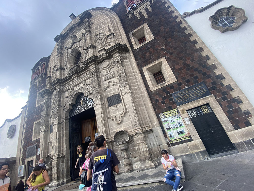 A visitor looks at the St. Joseph of Guadalupe Monastery, the brown part to the right of a chapel at the top of Tepeyac Hill, near the Basilica of Our Lady of Guadalupe in Mexico City Aug. 27. (GSR photo/Rhina Guidos)
