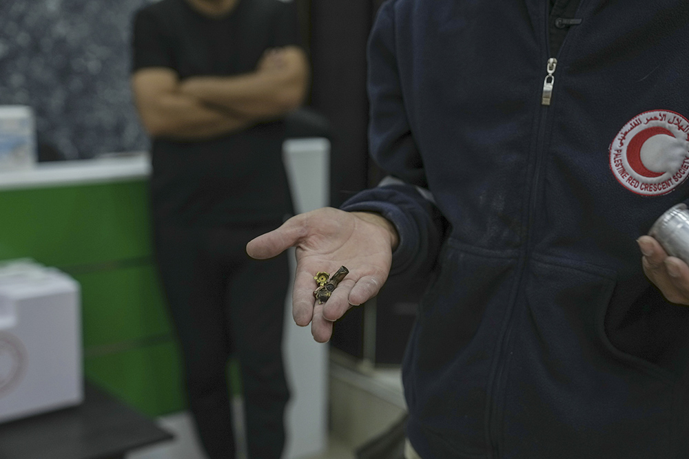 Bashar al-Qaryoute, a Palestinian Red Crescent medic, displays bullet casings that he says he has collected from attacks by Israeli settlers and soldiers on his ambulance in the village of Qaryout in the northern West Bank, Nov. 12. (AP/Mahmoud Illean)