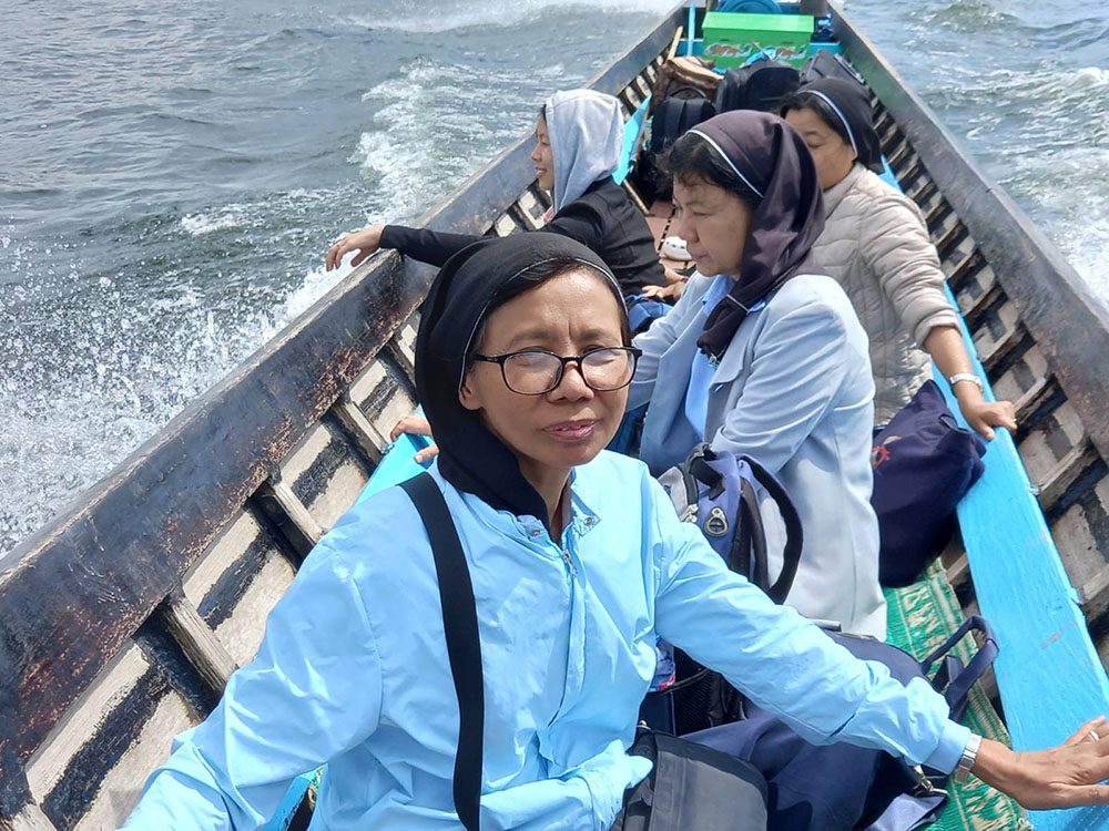 Good Shepherd Sisters use a boat to go to a safer location as fighting becomes more intense in Loikaw, Myanmar, in November. (Courtesy of Sister Florence) 