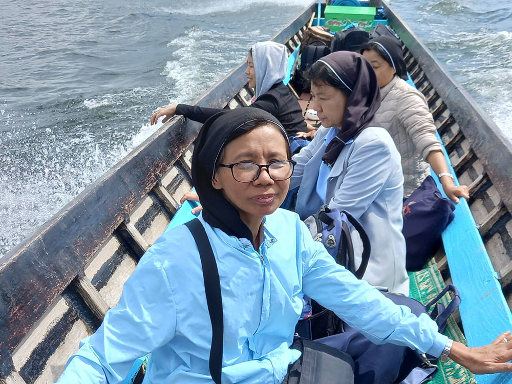 Good Shepherd Sisters use a boat to go to a safer location as fighting becomes more intense in Loikaw, Myanmar, in November. (Courtesy of Sister Florence)