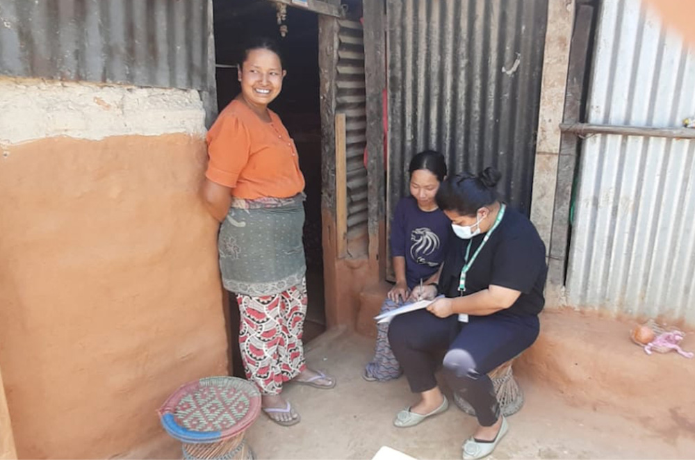 Cluny Sr. Durga Cecilia Shrestha visits women in a village in Nepal to collect details of women as part of a project. (Courtesy photo)