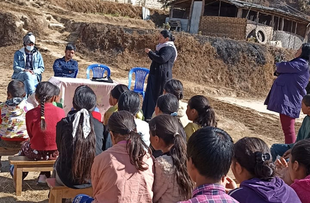 Cluny Sr. Durga Cecilia Shrestha (standing in front of the table) helps conduct a class for young children in a remote village in Nepal in this undated picture. (Courtesy photo)