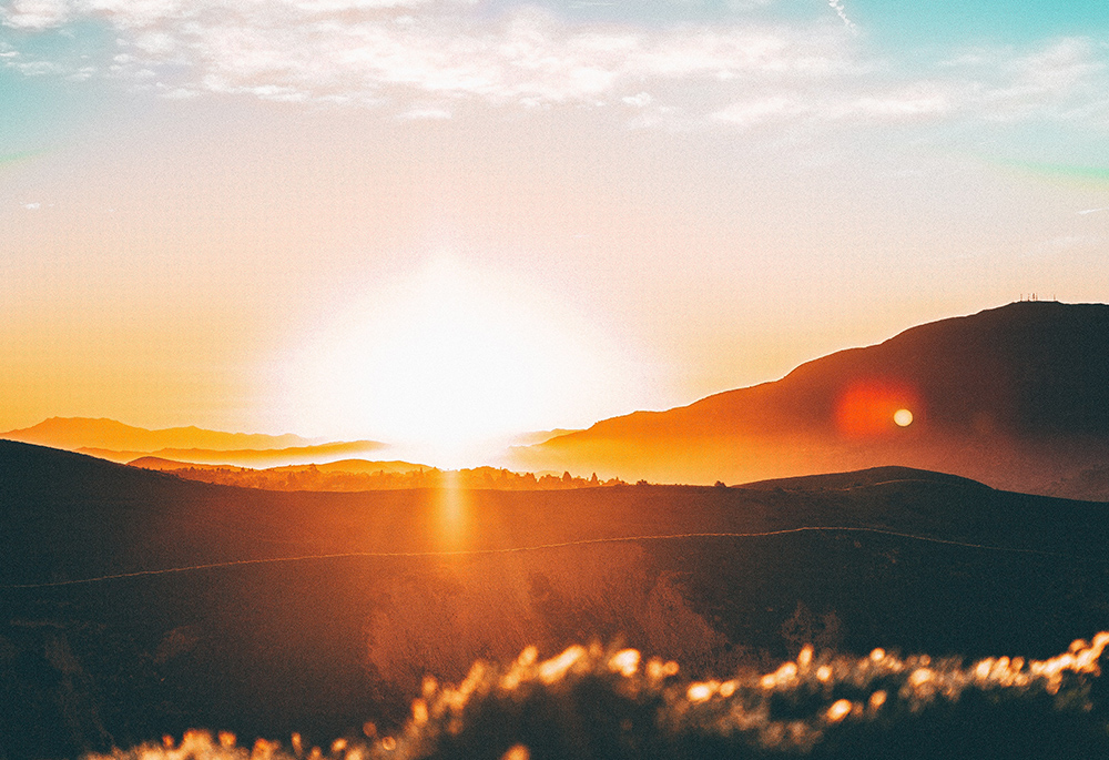 A sunrise is pictured in a photo of a horizon. (Unsplash/Jordan Wozniak)