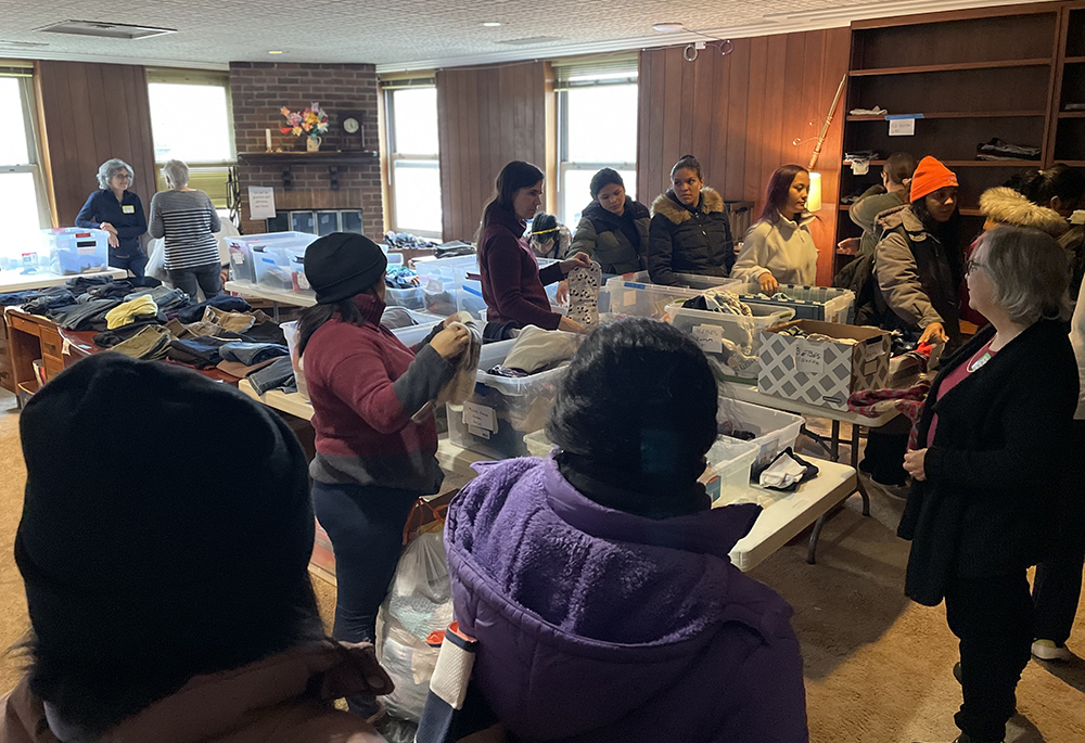 Migrants select clothing and blankets at the Migrant Ministry by the Catholic parishes of Oak Park, a suburb of Chicago. (Sue Paweski)