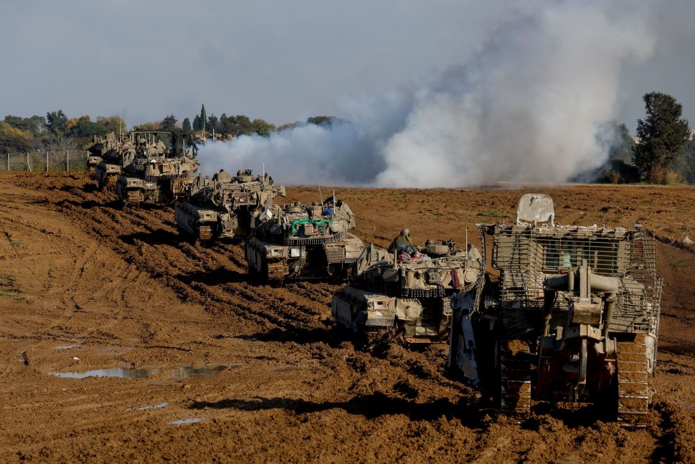 Israeli military vehicles move out of the Gaza Strip, as seen from southern Israel Jan. 15, amid the ongoing conflict between Israel and the Palestinian Islamist group Hamas. 