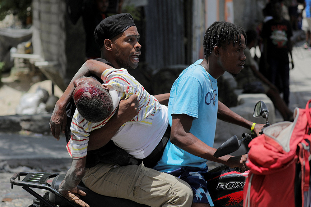 People take a wounded man to a hospital in Port-au-Prince, Haiti, Aug. 15, 2023, after gangs took over their neighborhood Carrefour-Feuilles. Vatican News reported Jan. 19, 2024, that armed men in Port-au-Prince took over a bus and kidnapped at least six nuns and others who were on the bus. The gunmen, who drove off with them to an unknown destination, were not immediately identified but authorities suspected they were gang members. (OSV News/Reuters/Ralph Tedy Erol)