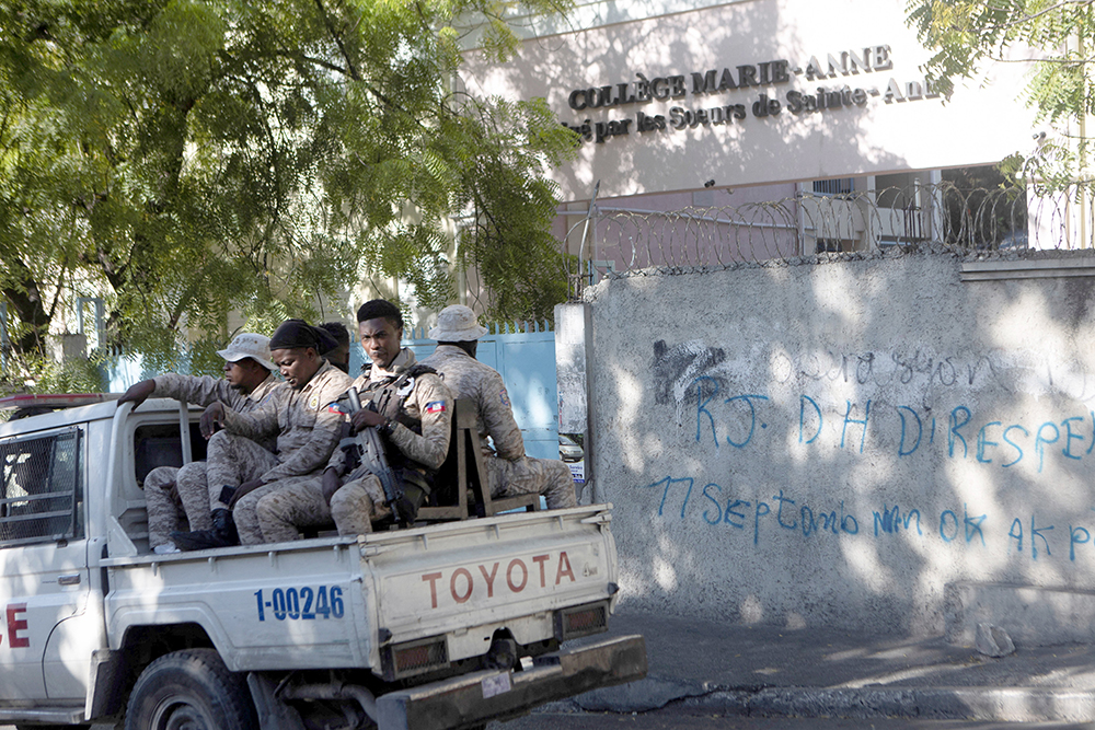 Haitian National Police patrol outside the College Marie-Anne in Port-au-Prince Jan. 22, 2024, days after six nuns were kidnapped by armed men while sisters were traveling on a bus. The nuns, who have since been freed, were abducted, along with other passengers on a bus, are members of the Sisters of St. Anne, the congregation that runs the college. (OSV News/Reuters/Ralph Tedy Erol)