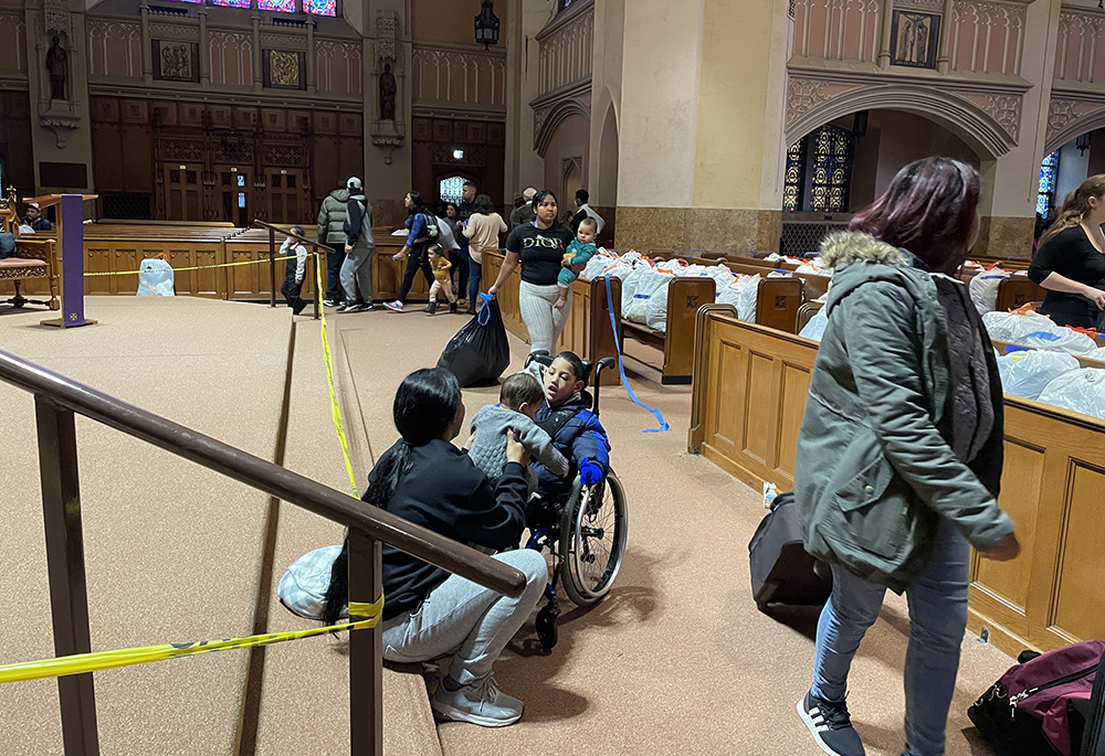 Individuals form a line for clothing and services at the Migrant Ministry by the Catholic parishes of Oak Park, a suburb of Chicago. (Sue Paweski)