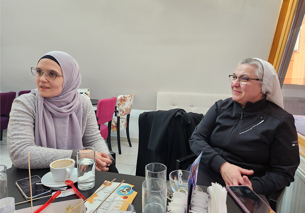Sr. Blanka Jeličić, 55, right, a Croatian-Slavonian music teacher and member of the Sisters of Mercy of St. Vincent de Paul, with her friend and colleague in interfaith cooperation, Šejla Mujić Kevrić, during an interview in a café in the city of Livno, Bosnia and Herzegovina. (GSR/Chris Herlinger)