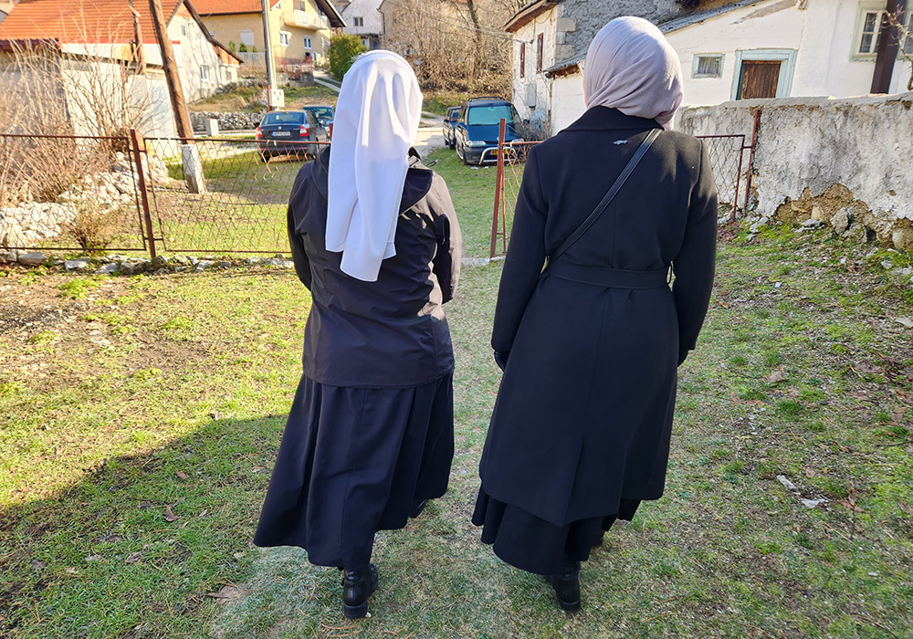 From the back, Sr. Blanka Jeličić, 55, left, a Croatian-Slavonian music teacher and member of the Sisters of Mercy of St. Vincent de Paul, with her friend and colleague in interfaith cooperation, Šejla Mujić Kevrić, as they walk down a path in the Bosnian city of Livno, Bosnia and Herzegovina. (GSR/Chris Herlinger)