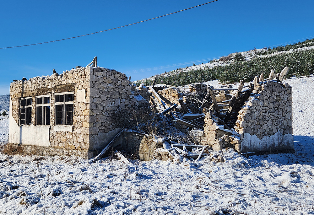 The landscape between the Bosnian cities of Jajce and Livno includes snow-covered plains, plateaus and mountains — and the occasional sighting of a shelled-out house, a tangible and physical reminder of the war of the 1990s. (GSR/Chris Herlinger)