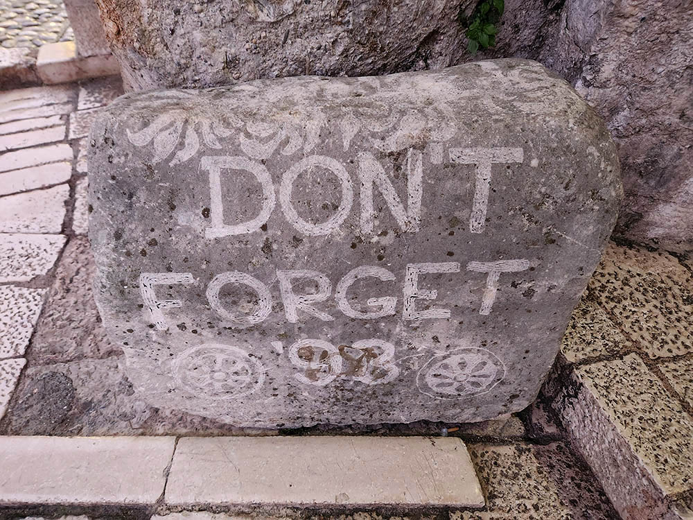 A large rock on the famous Mostar Bridge in the city of Mostar, Bosnia and Herzegovina, is emblazoned with the words: "DON'T FORGET '93" — a call for memorializing and also an alert to the dangers of forgetting the war of the 1990s. (GSR photo/Chris Herlinger)