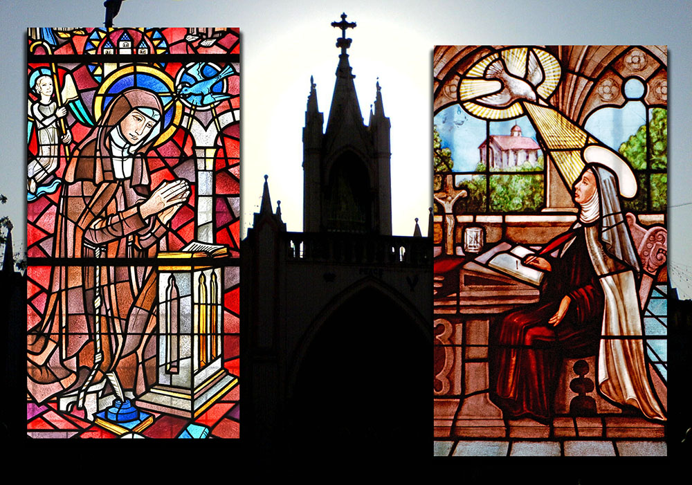 Left: St. Hildegard of Bingen depicted in stained glass in Koblenz, Germany (Wikimedia Commons/Thomas Hummel). Right: St. Teresa of Ávila depicted in stained glass in Ávila, Spain (Wikimedia Commons/Dennis Jarvis). Background photo: A view of the Basilica of Our Lady of the Mount in Bandra, Mumbai, India (Wikimedia Commons/Rakesh).