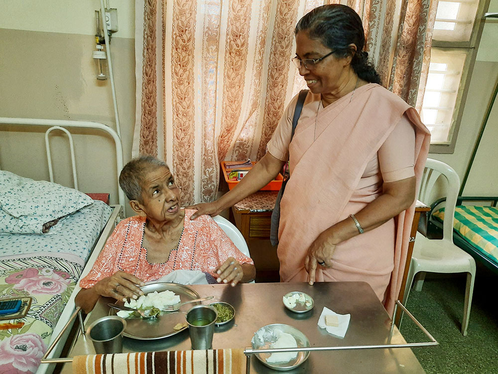 Sr. Stella Baltazar visits a sister admitted to a special facility for infirm nuns attached to a hospital managed by her congregation, the Franciscan Missionaries of Mary, in Coimbatore, Tamil Nadu state, India. (Saji Thomas)