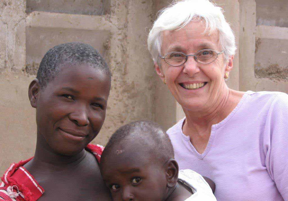 Sr. Connie Krautkremer of the New York-based Maryknoll Sisters served for nearly 50 years in Tanzania. Here she is with a mother and child she worked with during that time. (Courtesy of Sr. Connie Krautkremer)